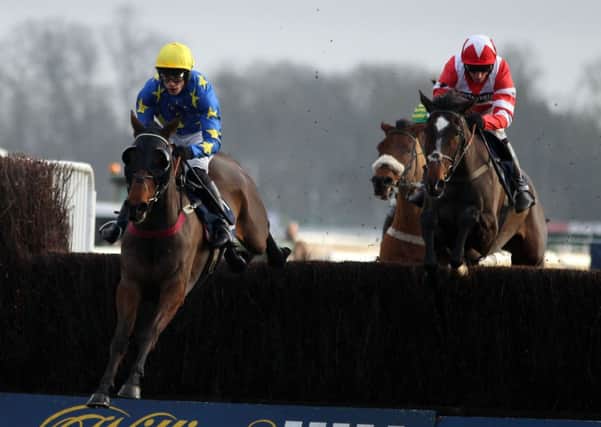 Annacotty (left) ridden by Ian Popham wins the Kauto Star Novices' Steeple Chase during Day One of the William Hill Winter Festival at Kempton Park Racecourse.