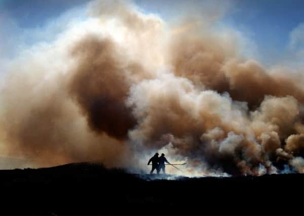 Gamekeepers burn the peat on Westerdale Moor, near Castleton, on the North Yorkshire Moors.