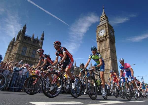 Riders pass the Clock Tower of the Palace of Westminster as they  leave London during the Tour de France Stage One London To Canterbury in 2007.