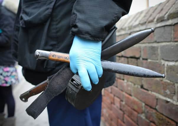 Weapons being removed from the property in Penistone. Pictures: Ross Parry Agency
