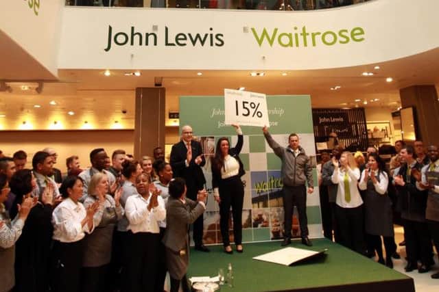 Simon Fowler, MD of John Lewis Oxford Street and John Lewis partner Chloe Bye and Waitrose Partner Stephen Burrows as the John Lewis partnership announce their full-year results