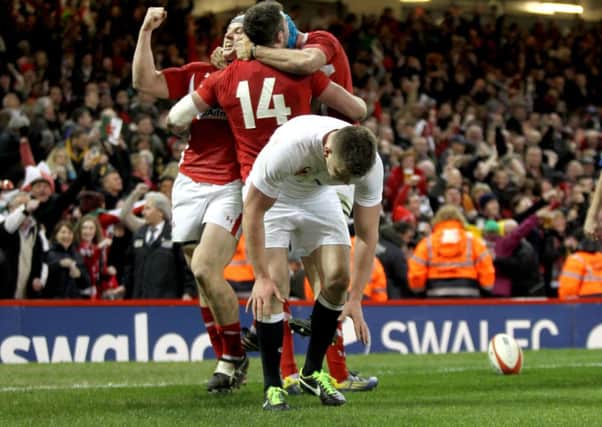 Wales Jonathan Davies leads the celebrations for Alex Cuthbert's first try during the RBS Six Nations match at the Millennium Stadium, Cardiff in 2013.