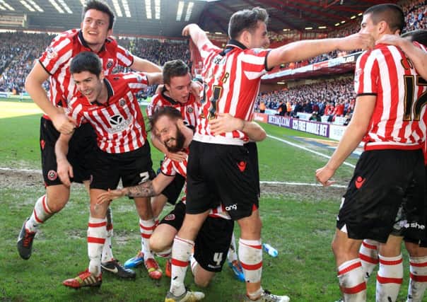 Sheffield United's John Brayford (centre) celebrates scoring their second goal of the game with team-mates during the FA Cup Sixth Round match at Bramall Lane, Sheffield.