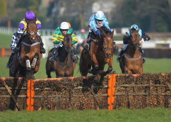 Balitimore Rock (right) ridden by Tom Scudamore wins the William Hill Imperial Cup Handicap Hurdle.