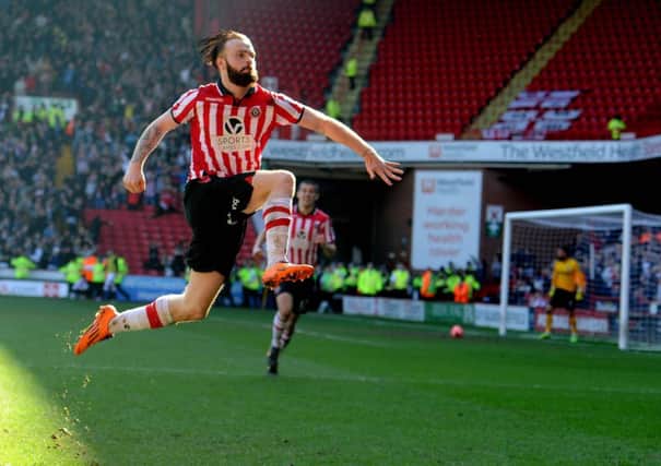Sheffield United's John Brayford, leaps into the air to celebrate scoring the second goal of the match.