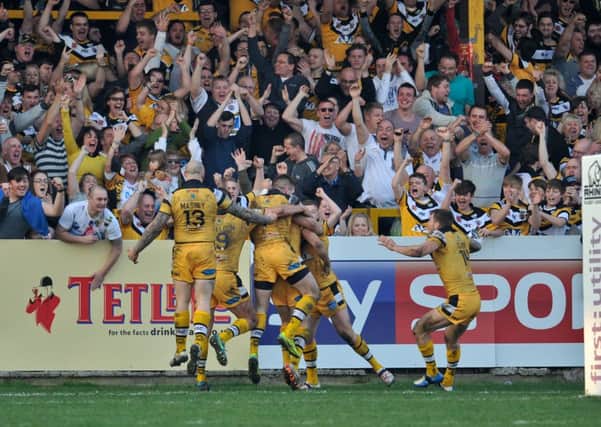 Castleford Tigers fans and players celebrate as Luke Dorn runs in the final try.