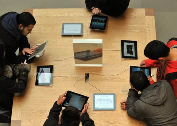 A family tries out the devices at an Apple store