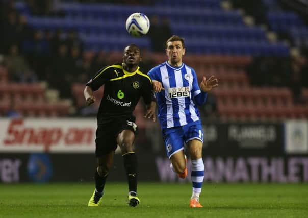 Wigan's James McArthur and Sheffield Wednesday's Adedeji Oshilaja (left) challenge for the ball.