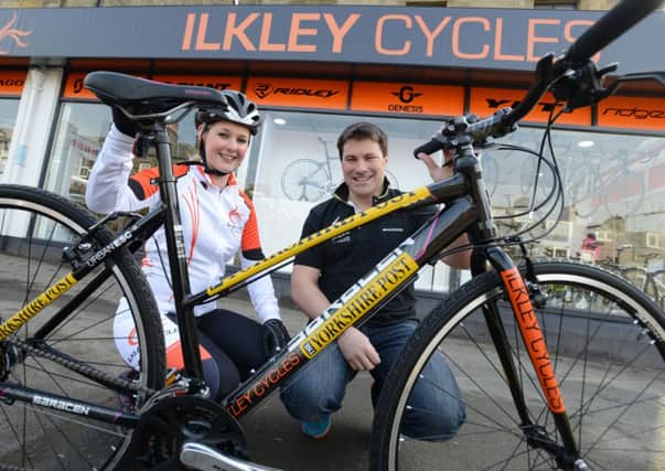 Laura and Adam Evans of Ilkley Cycles with The Yorkshire Post bike which will be used for the first Go the Mile event at Ilkley Cycles on Saturday. Picture Bruce Rollinson