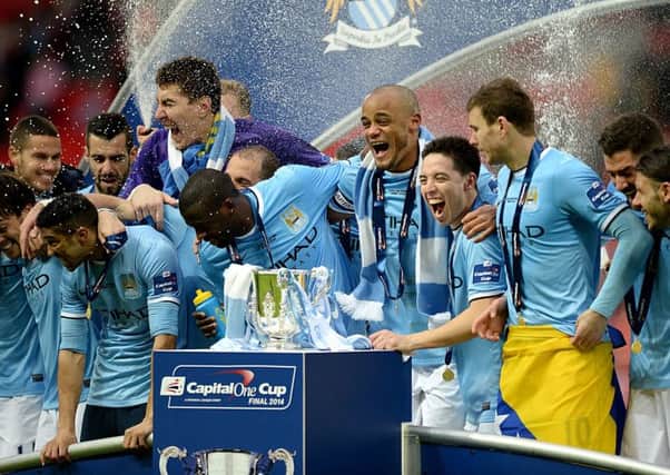 Manchester City players celebrate victory in the Capital One Cup Final at Wembley Stadium, London.