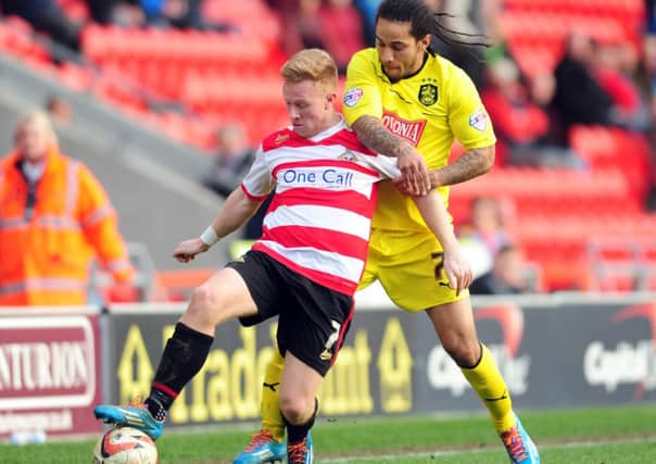 Doncaster Rovers' Mark Duffy holds off Huddersfield Town's Sean Scannell. Will either feature for their respective teams this weekend? Find out here.
