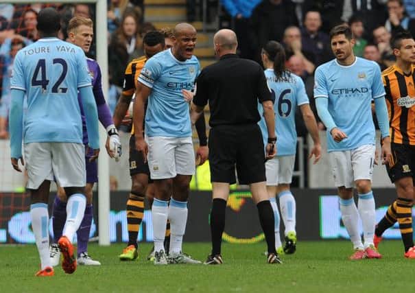 Manchester City's Vincent Kompany argues with referee Lee Mason after being sent off during the Barclays Premier League match at the KC Stadium, Hull.
