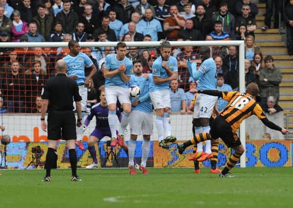 Hull City's Nikica Jelavic strikes his free kick against the Manchester City wall during the Barclays Premier League match at the KC Stadium, Hull.