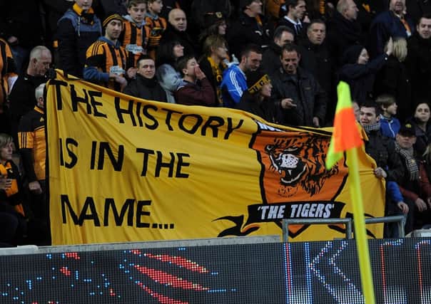 Hull City fans hold up a banner that reads 'The History is in the name...' during a Premier League match at the KC Stadium, Hull.