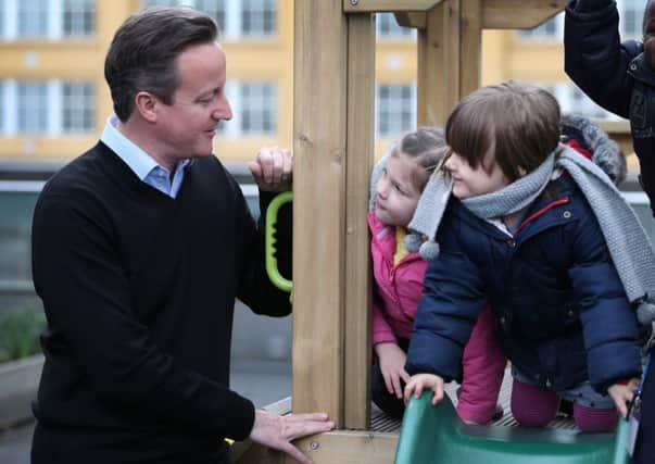 Children meet Prime Minister David Cameron during a visit to the Coin Street nursery in London