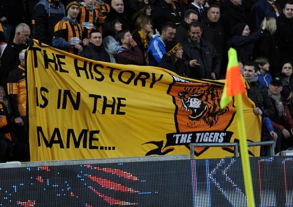 Hull City fans hold up a banner that reads 'The History is in the name...' during the Barclays Premier League match at the KC Stadium, Hull.
