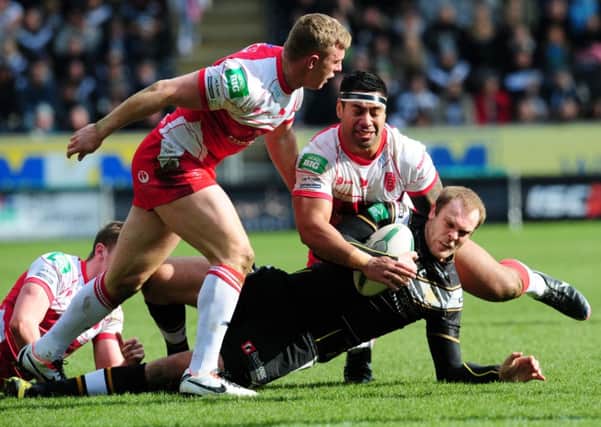 Hull FC's Richard Whiting is tackled by Hull Kingston Rovers' Graeme Horn and Micky Paea