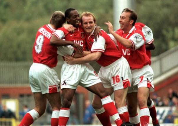 Arsenal's Paul Merson (left) John Hartson (centre) and David Platt as they celebrate with double goal scorer Ian Wright on Arsene Wenger's first game in charge in 1996.