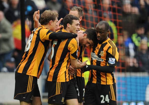 Hull City players congratulate Shane Long after he scored his side's second goal during the Barclays Premier League match at the KC Stadium, Hull.