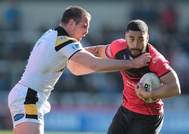 Rangi Chase is tackled by Andy Lynch.
