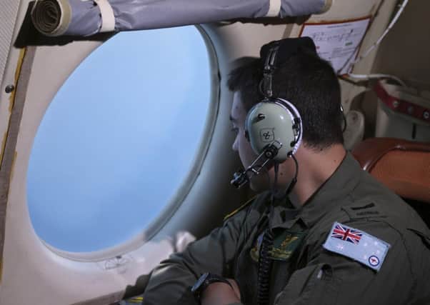 Sgt. Matthew Falanga on board a Royal Australian Air Force AP-3C Orion, scans for the missing Malaysia Airlines flight