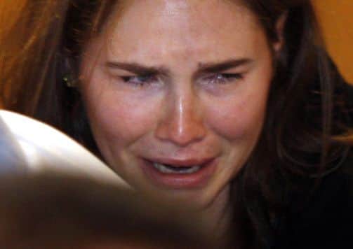 Amanda Knox  breaks into tears after hearing the verdict that overturns her conviction and acquits her of murdering her roommate Meredith Kercher
