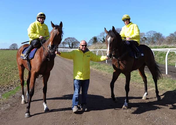 Trainer Richard Fahey (centre) with Gabrial's Kaka ridden by Barry McHugh (right) and Hi There ridden by Tony Hamilton at Mews House Stables, Malton.