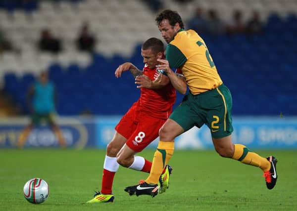 Wales' Craig Bellamy (left) and Australia's Lucas Neill (right)