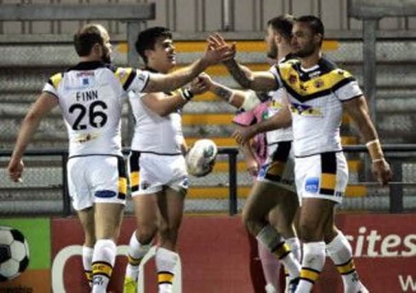 Michael Channing, second left, is congratulated after scoring a try against London.