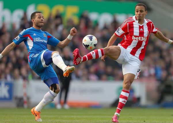 Stoke City's Peter Odemwingie (right) and Hull City's Liam Rosenior compete for the ball.
