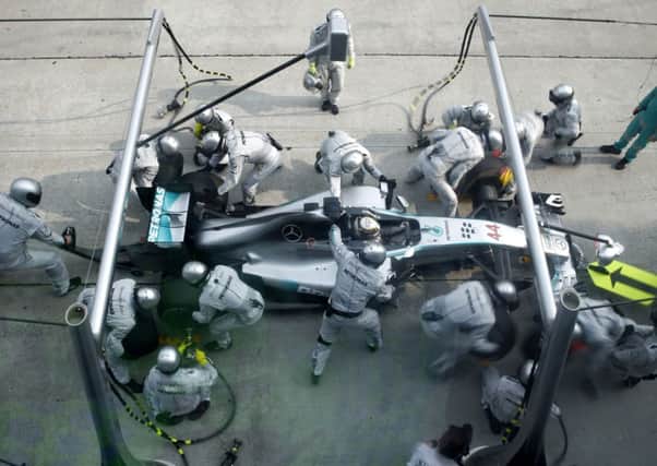 The pit crew for Mercedes driver Lewis Hamilton of Britain change his tires during the Malaysian Formula 1 Grand Prix.