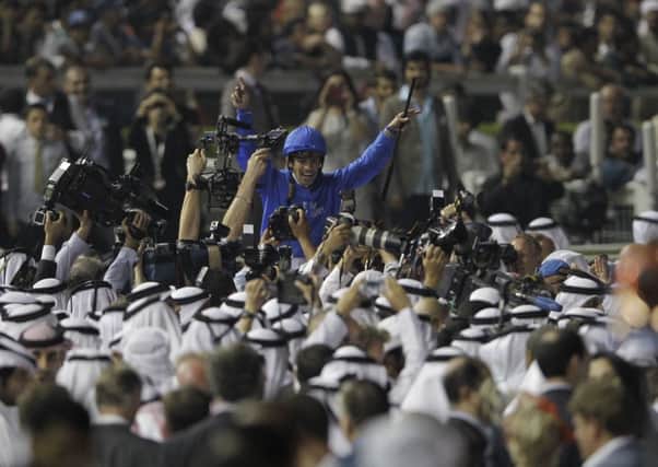 Silvestre De Sousa, riding African Story, celebrates after winning the world's richest horse race Dubai World Cup at Meydan. Picture: AP/Kamran Jebreili.