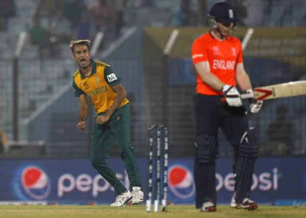 COMING HOME: South Africa's Imran Tahir, left, celebrates the dismissal of England's Eoin Morgan in Chittagong.