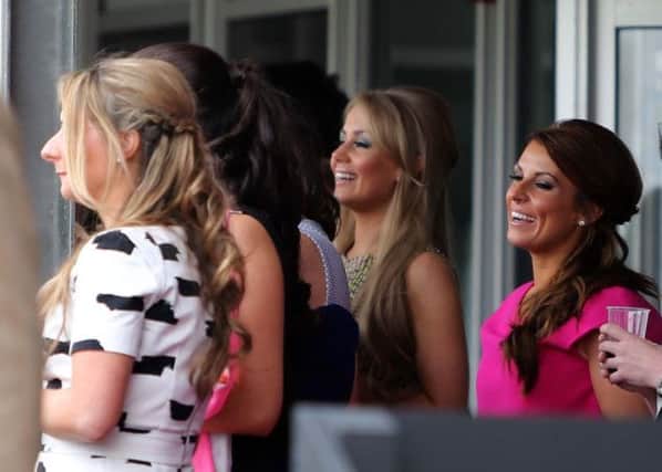 Coleen Rooney (second right) watches the races during the Crabbie's Grand National 2014, Grand Opening Day at Aintree