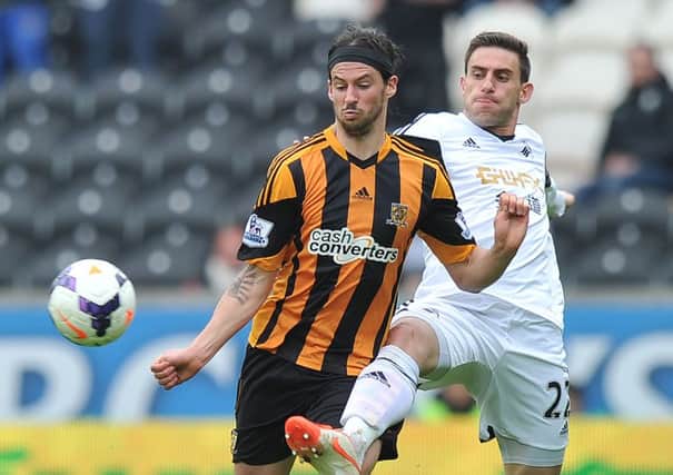 Hull City's George Boyd (left) and Swansea City's Angel Rangel battle for the ball.