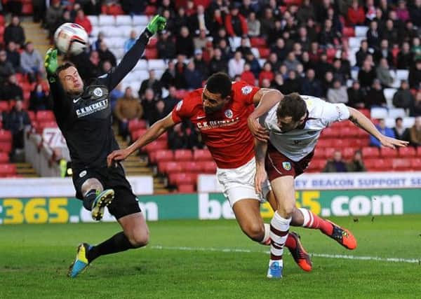 Burnley's Ashley Barnes heads the only goal of the game past Barnsley's goalkeeper Luke Steele (Picture: Nigel French/PA Wire).