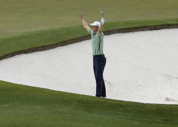 Jordan Spieth celebrates after chipping in for an birdie from a bunker on the fourth hole