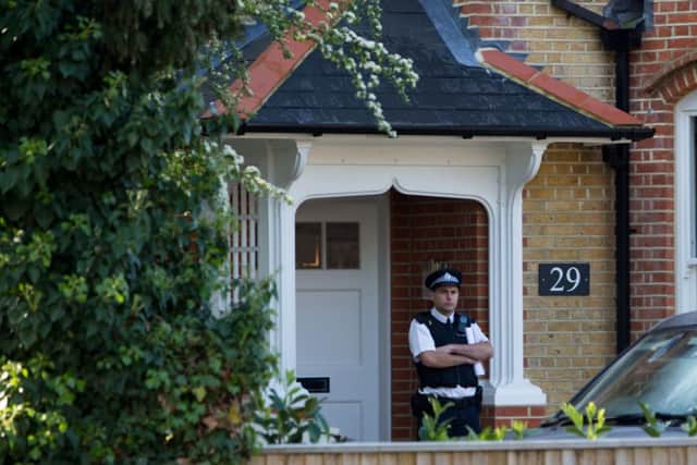 Police at a house in New Malden, south London, after a woman was arrested following the discovery of three dead children at the address.