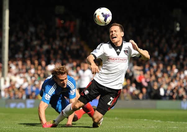 Fulham's Sascha Riether (right) and Hull City's Nikica Jelavic (left) battle for the ball.
