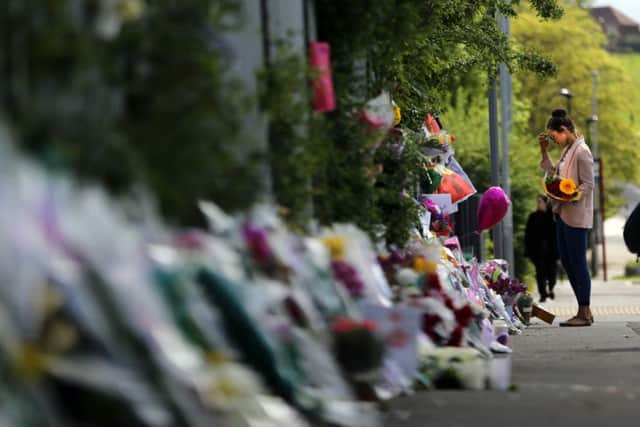 Flowers, photographs and notes left in memory of teacher Ann Maguire outside Corpus Chriti School in Leeds. Picture: Ross Parry Agency