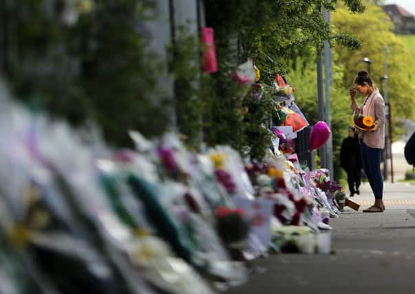 Flowers, photographs and notes left in memory of teacher Ann Maguire outside Corpus Chriti School in Leeds. Picture: Ross Parry Agency