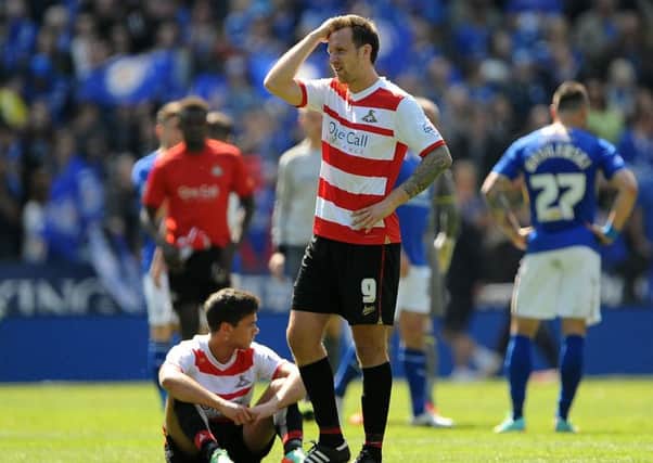 Doncaster Rover's Chris Brown shows his dejection after relegation is confirmed at Leicester City.