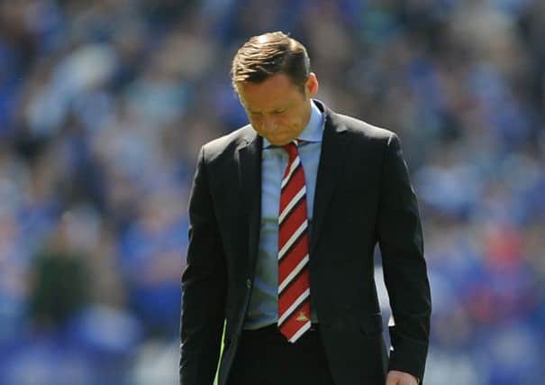 Doncaster Rovers manager Paul Dickov shows his dejection after the game against Leicester City.