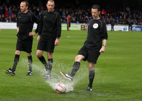 Ian Cooper, Carl Boyeson and Dean Treleaven test the pitch before the Sky Bet League Two, Play-off Semi Final, First Leg at Bootham Crescent, York.
