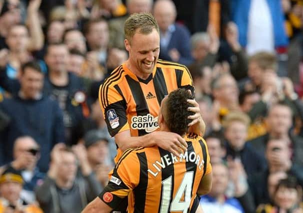 Hull City's David Meyler (left) celebrates scoring their fifth goal of the game with team-mate Jake Livermore during the FA Cup Semi Final match at Wembley Stadium, London.