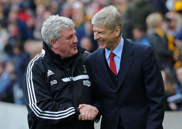 Steve Bruce and Asene Wenger shake hands before kick off in the recent Premier League match.