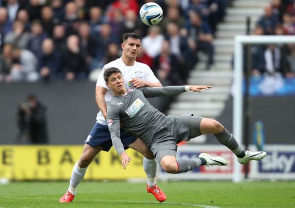 Preston North End's Bailey Wright and Rotherham United Alex Revell battle for the ball.
