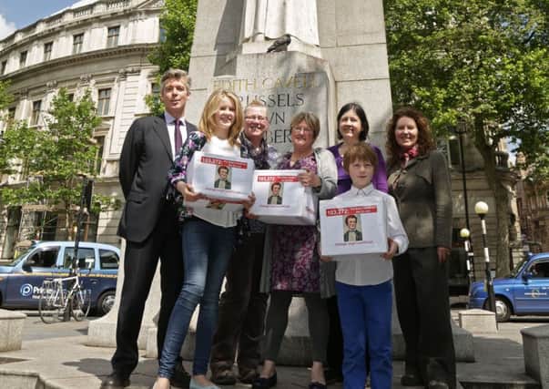 Nurses and family of World War I nurse Edith Cavell (left to right) Robert Tunmore, Pip Smith, Helen Peyton, Sheffield City Councillor Sioned-Mair Richards (who started the petition), Rosanne Kirk, Kit Smith and Jane Peyton by her statue in St Martin's Place, London, before delivering a 100,000 strong petition at HM Treasury calling for her to be commemorated on a £2 coin to mark the Great War's centenary.