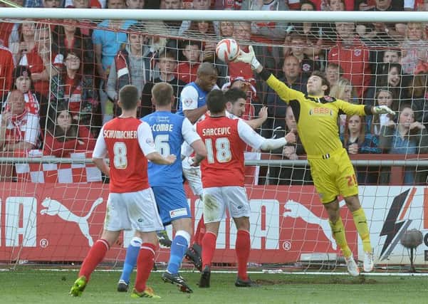 Fleetwood Town goalkeeper Chris Maxwell saves a header from York City's Calvin Andrew.