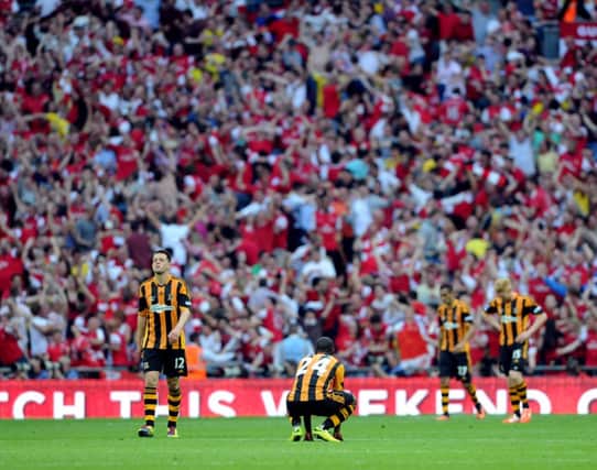 END GAME: Hull's players show their dejection after the final whistle. Picture: James Hardisty.